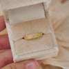 Woman holding velvet ring box featuring vintage vintage-inspired antique star band.