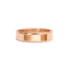 A man's wedding band with floral engraving set in 14k rose gold.