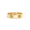 A man's wedding band with floral engraving set in 14k yellow gold.