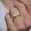 Woman wearings a stacked diamond engagement ring with criss cross engraved wedding band.