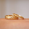Two floral engraved yellow gold wedding bands.