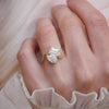 Captivating blend of shapes, this toi et moi ring pairs the graceful curves of a pear diamond with the sharp lines of an emerald diamond, making it an ideal choice for a unique and modern design.