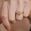 Woman wearing a champagne diamond emerald cut solitaire ring
