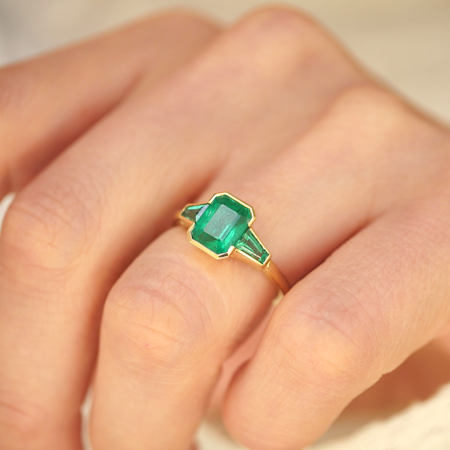 Emerald Bezel Trio Engagement Ring
