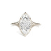A white gold band ring with a single marquise cut diamond.