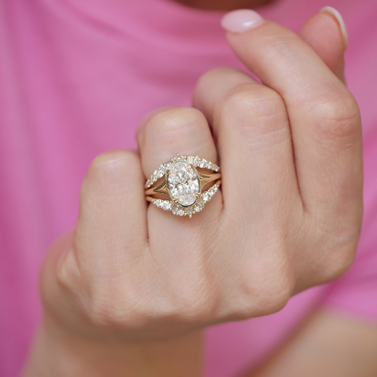 This split shank engagement ring, featuring oval brilliant cut diamonds, is paired with elegant diamond contour wedding bands that curve to perfection, creating a seamless and sparkling bridal set.
