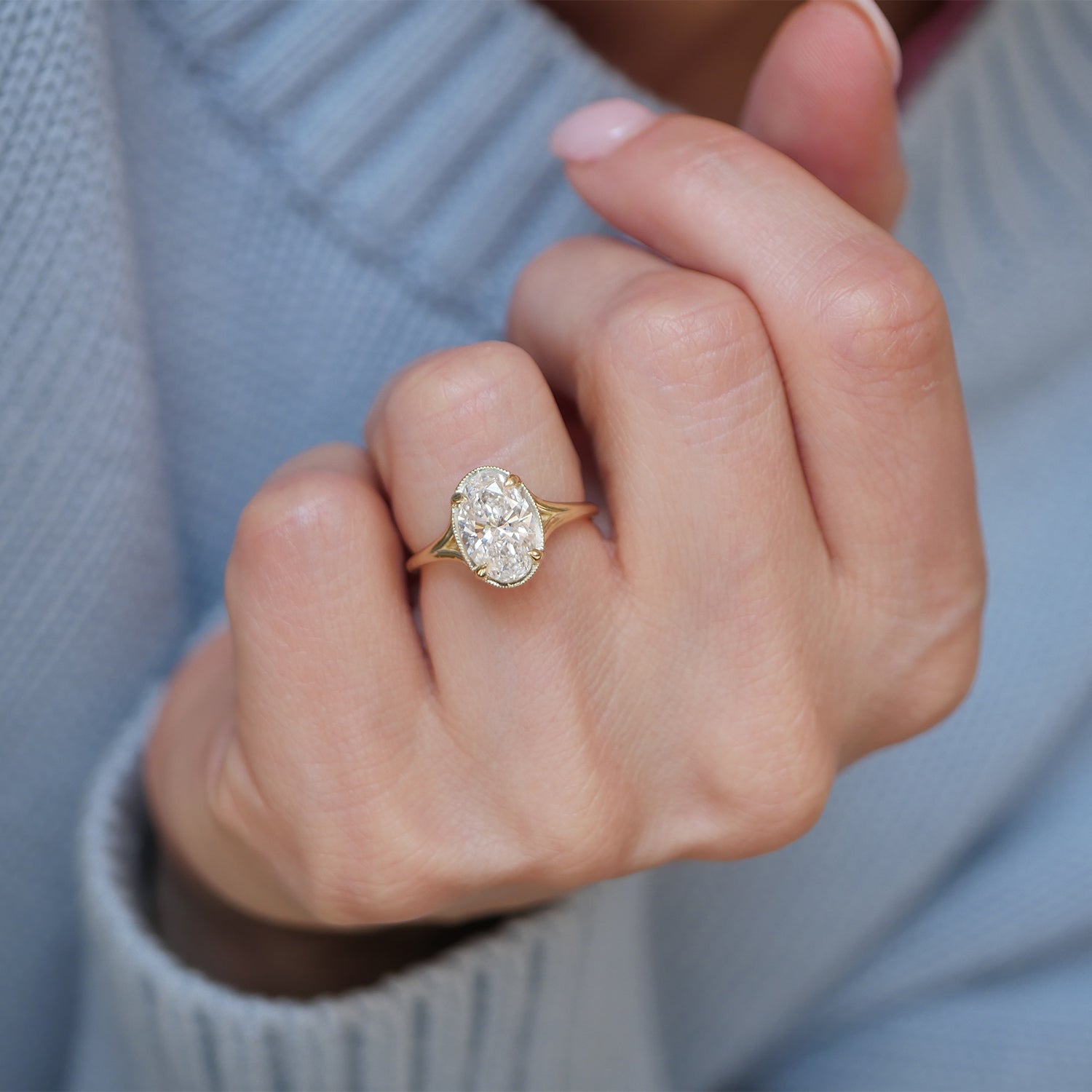 Featuring oval brilliant cut diamonds in a unique split shank design, this engagement ring is paired with matching diamond contour bands, creating a flawless and sophisticated bridal set.