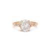 Rose gold ring with a large diamond and smaller diamonds on the band.