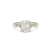 Diamond ring with a large central gemstone and smaller stones on a 14k white gold