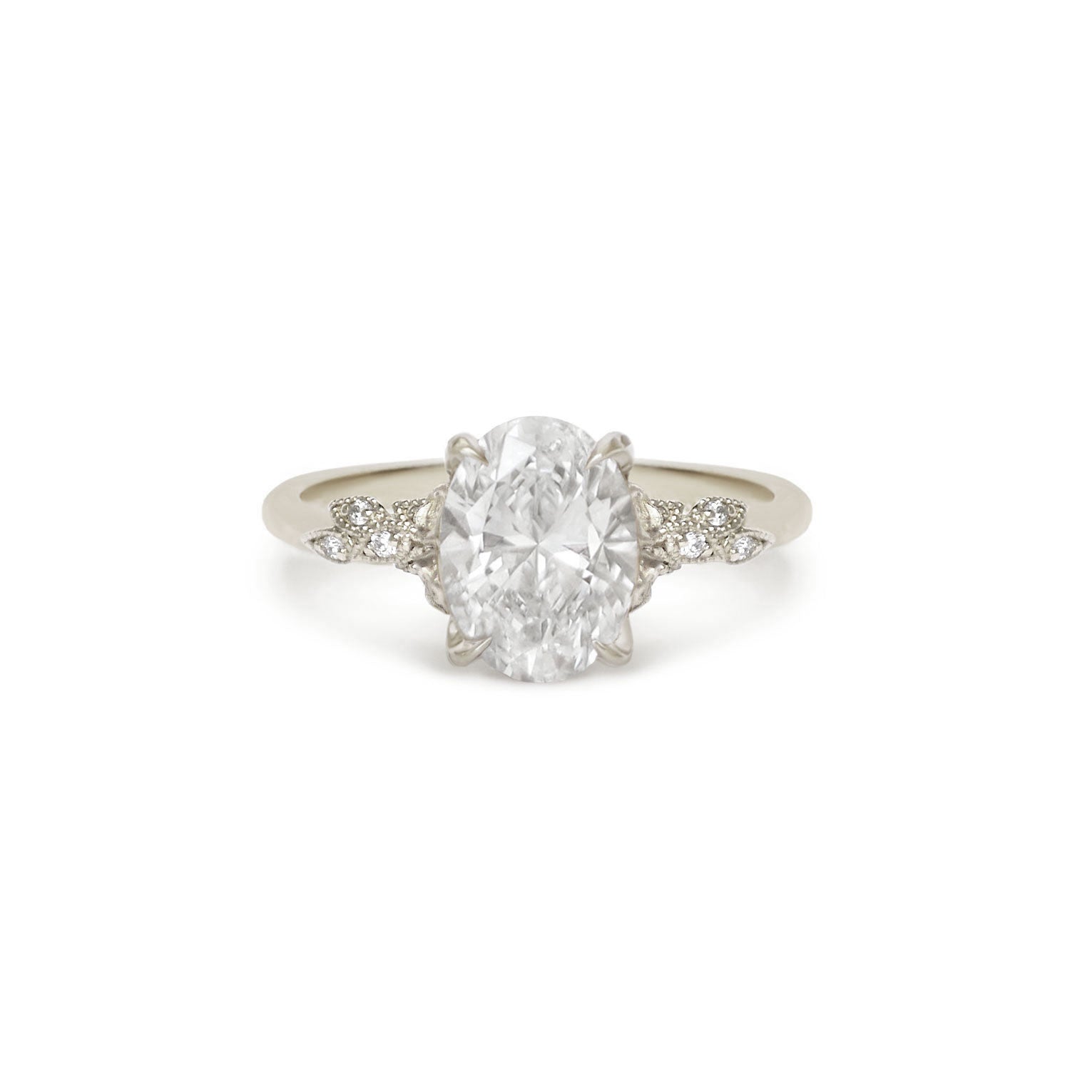 Diamond ring with a large central gemstone and smaller stones on a 14k white gold