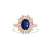 A sapphire and old European cut diamond cluster ring set in a yellow gold ring.