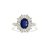 A white gold blue sapphire and diamond cluster ring.