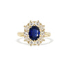A yellow gold blue sapphire and diamond cluster ring.