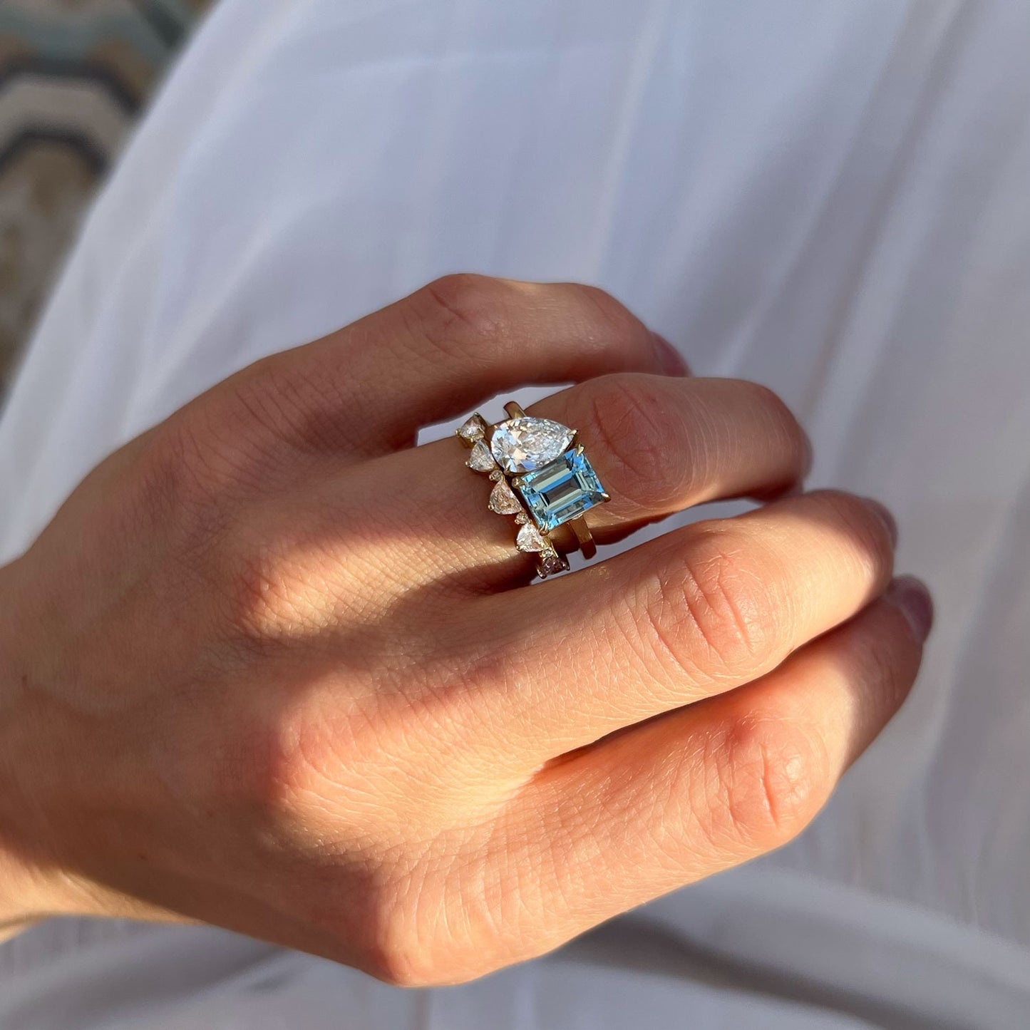 This beautiful ring symbolizes unity and love with its intertwined setting, where the aquamarine and pear diamond represent two souls coming together in perfect balance.