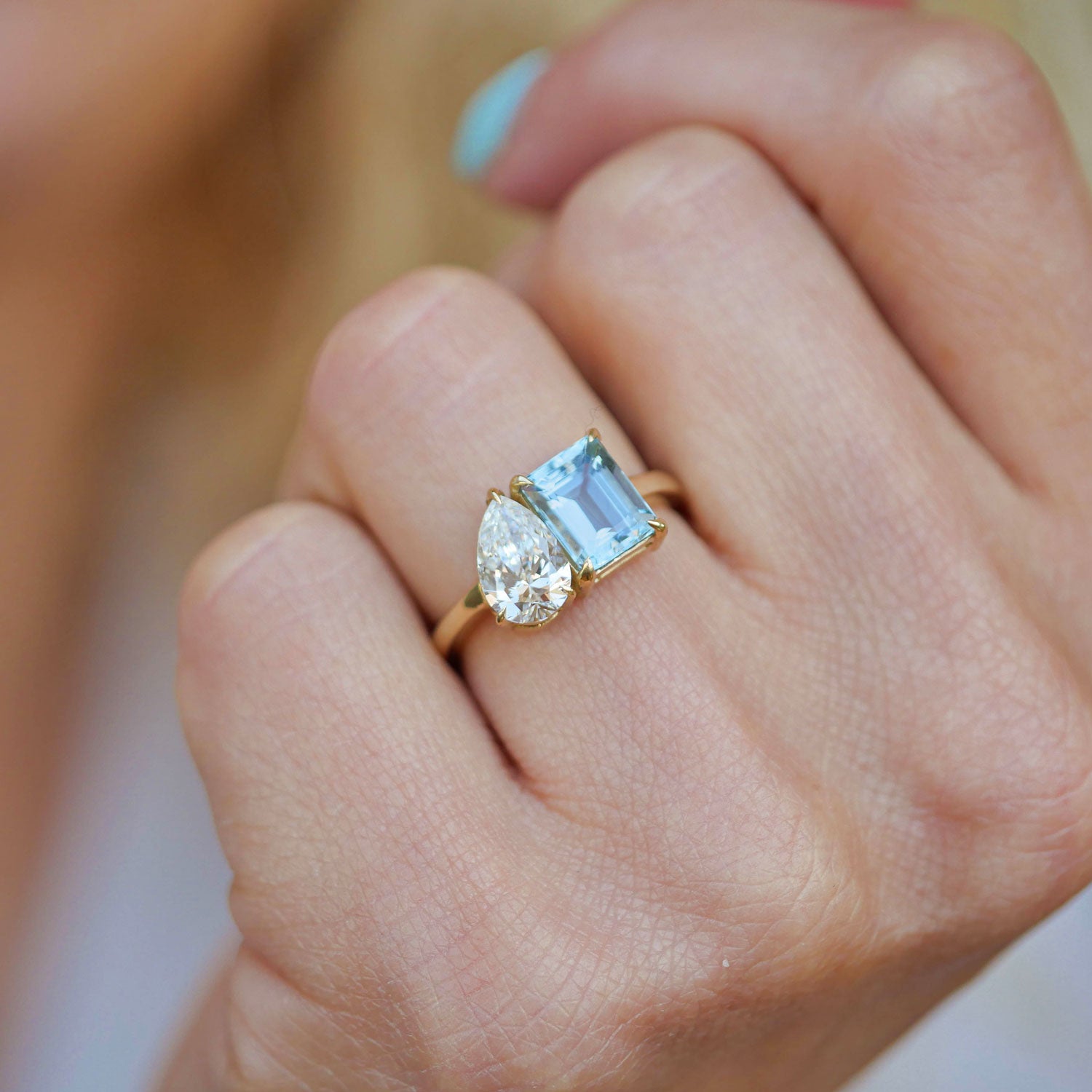 With its delicate color palette, the ring pairs the soothing hue of aquamarine with the brilliance of a pear-shaped diamond, creating a sophisticated yet modern look.