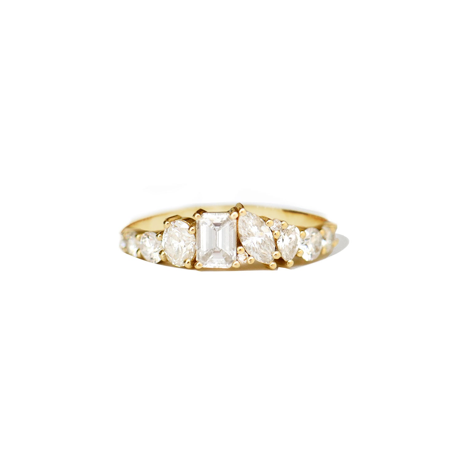 The Emerald & Marquise Firework Diamond Mosaic Band combines the bold elegance of emerald-cut diamonds with the graceful curves of marquise diamonds, creating a striking contrast in a unique design.